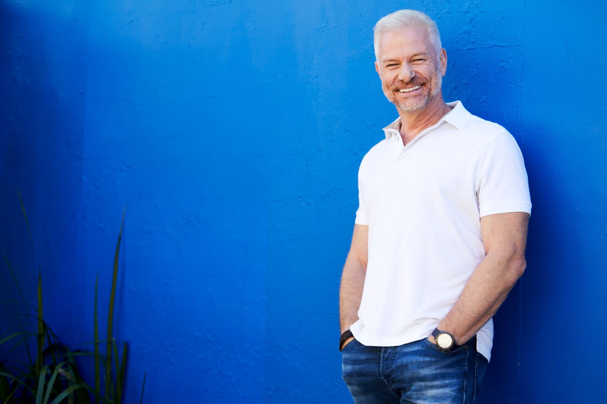 David Francis standing against a cobalt blue wall
